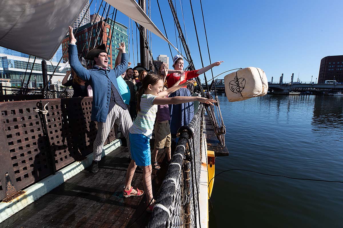 guests throwing tea overboard at Boston Tea Party Ships & Museum