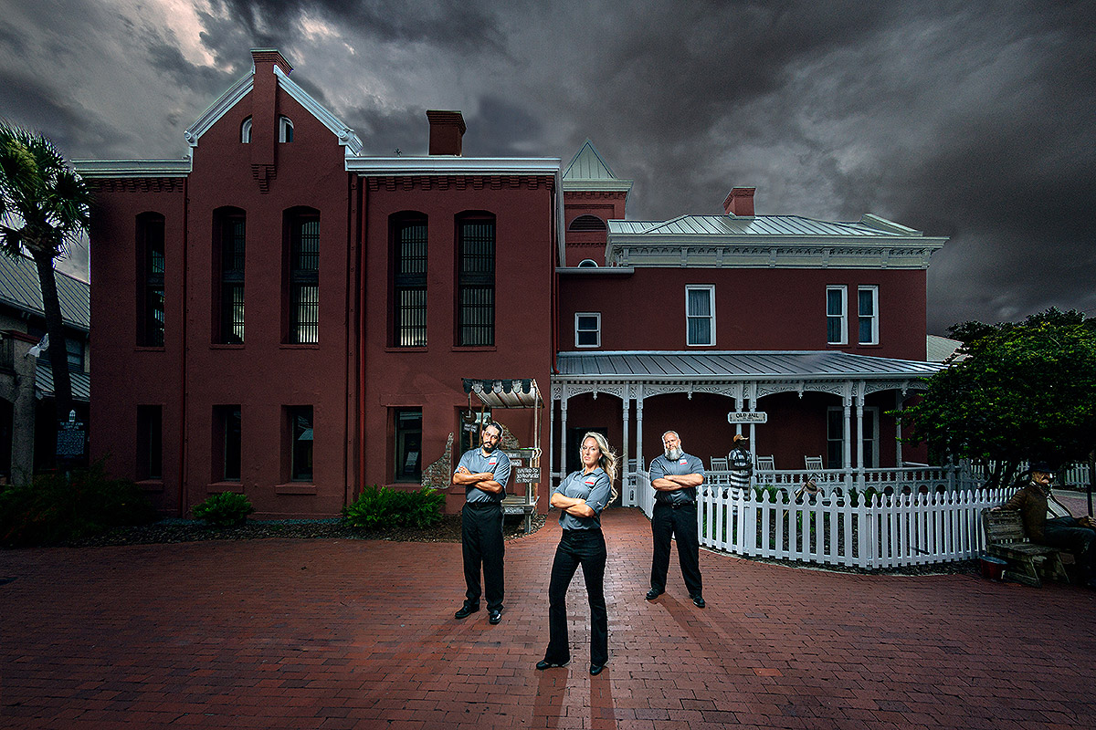 three tour guides standing in front of St. Augustine Old Jail