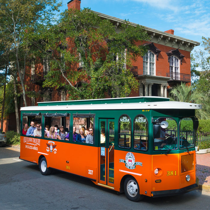 Old Town Trolley in front of landmark in Savannah