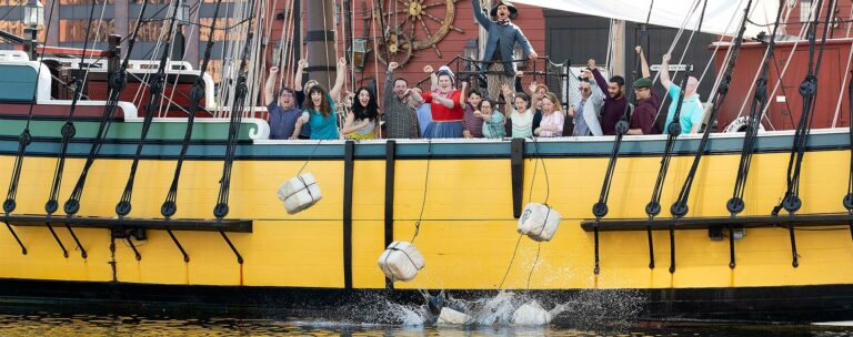 guests throwing tea overboard at Boston Tea Party Ships & Museum