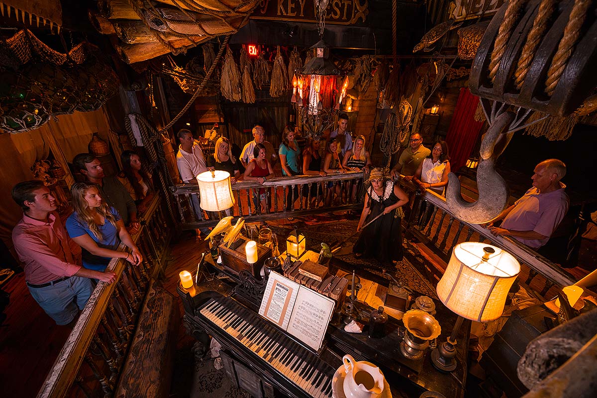 guests and hosts inside Key West Shipwreck Museum during a Ghosts & Gravestones tour