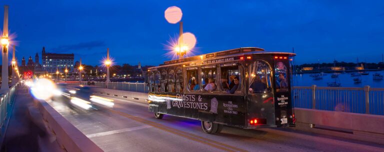 Ghosts & Gravestones trolley in St. Augustine driving over the bridge of Lions