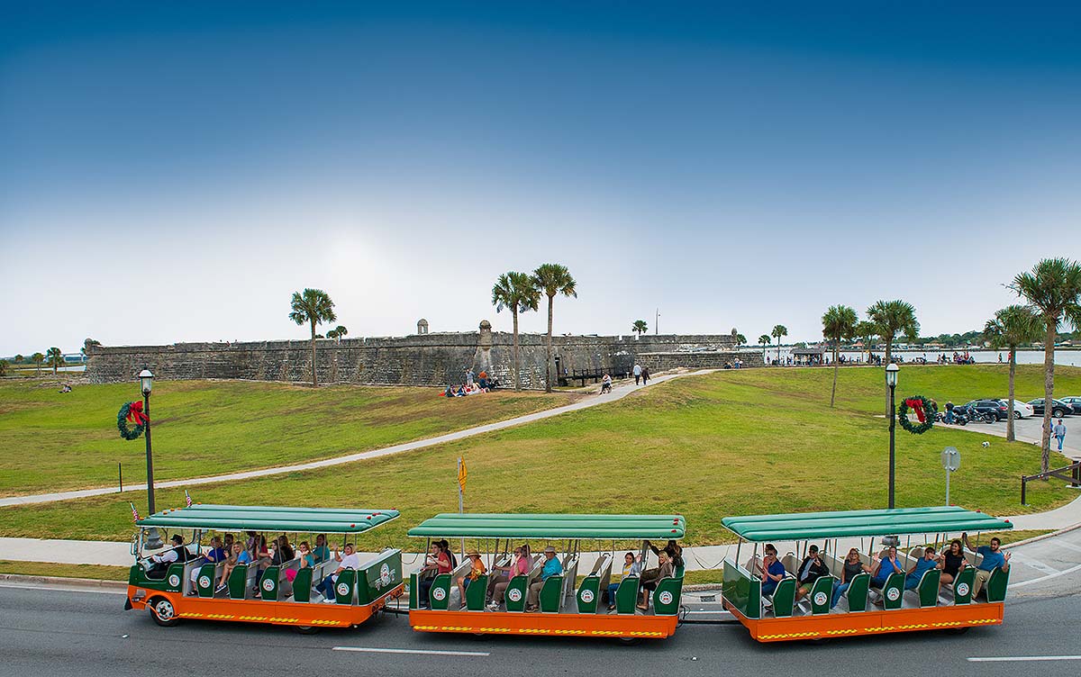 St. Augustine Old Town Trolley driving past Castillo de San Marcos