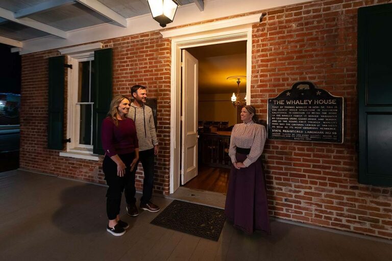 host welcoming guests to the Whaley House