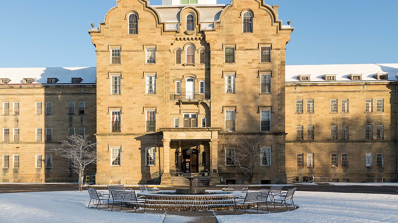 haunting exterior of Trans-Allegheny Asylum, featuring crumbling walls