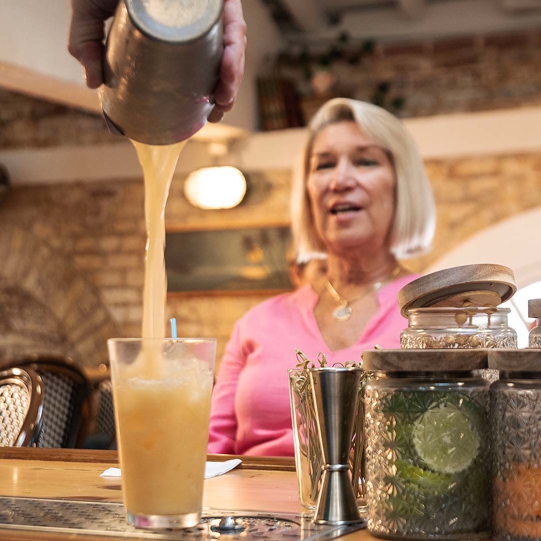 guest being served cocktail at Key West Cooking School