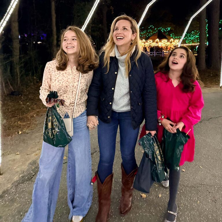 family exploring Charleston holiday lights display