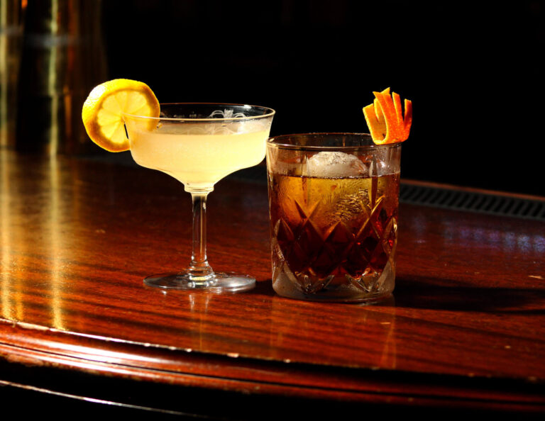 Southside and Hanky Panky cocktail in different glasses on a rustic wooden table